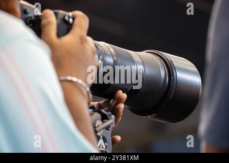 Close-up of a photographer using telephoto lens to captured a moment Stock Photo