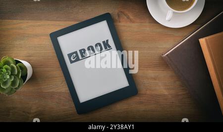Reading concept at home with ebook with text on screen on wooden table with coffee, traditional books and decoration.. Top view Stock Photo