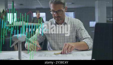 Image of graph processing data over caucasian male architect working on blueprints Stock Photo