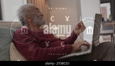 Image of currency icons and data processing over biracial man paying online with card Stock Photo