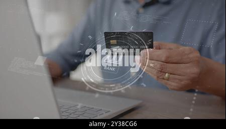 Image of currency icons and data over biracial man paying online with card Stock Photo