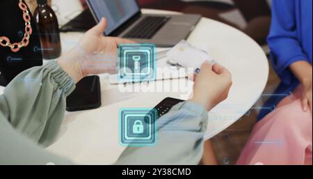 Image of padlock icons over caucasian woman paying online with card Stock Photo
