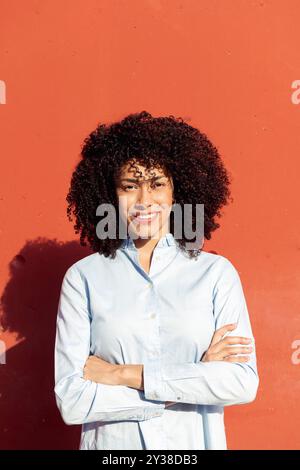 female entrepreneur standing with crossed arms Stock Photo