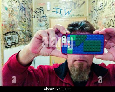 Selfie in Restroom Self Portrait / Selfie in Cafe Weemoed s Restroom using a Apple iPhone Smartphone with Lego Nack. Tilburg, Netherlands. MRYES Tilburg Cafe Weemoed Noord-Brabant Nederland Copyright: xGuidoxKoppesxPhotox Stock Photo