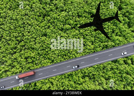 Sustainable transport. Aerial view of eco-friendly vehicles on highway. Electric cars, hydrogen trucks, and SAF-powered airplane shadow over green Stock Photo