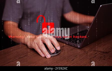 Cybersecurity and safety concept. A padlock is unlocked or hacked with a warning text, while using a notebook computer.  Cyber attack,  unsecured netw Stock Photo