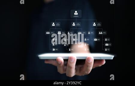 Hierarchy structure concept. Businessman with organization chart shown on the tablet. Company or business hierarchical organizational Stock Photo