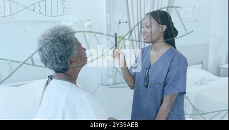 Image of dna strands over african american female doctor checking sight of senior female patient Stock Photo