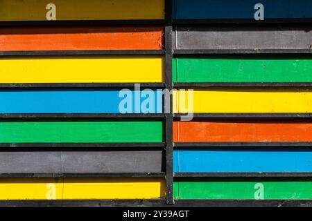 multicolored wooden planks on wall of house in Dilijan city, Armenia on sunny summer day Stock Photo