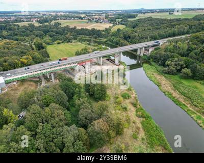 12 September 2024, Saxony, Grimma: The new Mulde bridge on the A14 near Grimma is being pushed over the Mulde valley using the incremental launching method in the third of seven planned shifts. This means that the bridge will grow by 40 meters in length within two days. The structure is to replace the old highway bridge from the 1970s, according to the highway construction company Deges. The new bridge will be 361 meters long and will cross the Mulde River at a height of around 21 meters. The project costs of 81 million euros will be borne by the federal government. Completion is planned for 2 Stock Photo