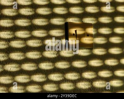 Sunset Glow: Power of Light. Blinds reflection on the wall. Pattern and texture. Stock Photo