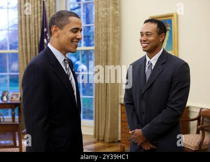 President Barack Obama greets professional golfer Tiger Woods in the Oval Office Monday, April 20, 2009. The 14-time major winner visited the White House Monday following a press conference for the AT&T National, the PGA Tour event Woods hosts at Congressional Country Club June 29-July 5. Official White House Photo by Pete Souza Stock Photo