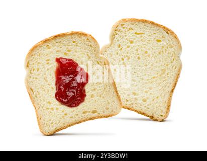 Slices of white bread with strawberry jam spread on white background. Stock Photo