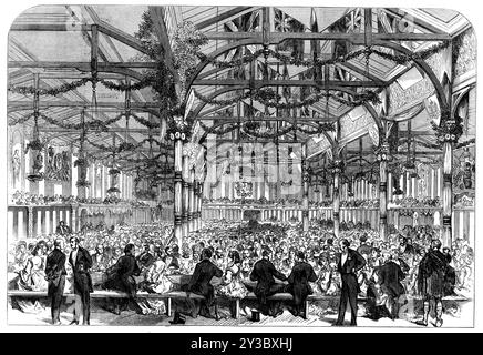 The Scott Centenary Banquet in the Corn Exchange, Grassmarket, Edinburgh, 1871. The celebration...of the hundredth anniversary of Sir Walter Scott's birth...was a very spirited affair...Our Illustration gives a view of the interior of the great hall, with its profuse decorations, and the closely-packed assemblage of 2000 ladies and gentlemen, seated at eighteen narrow tables across the width of the hall...there were statuettes and painted figures of various historical, poetical, or mythological character, ranged along the galleries; and from the roof, alternating with pendent gas-burners and w Stock Photo