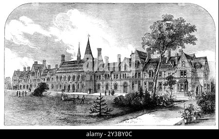 The new grammar school at Reading, 1871. 'The new building...has been constructed...for the purpose of establishing at Reading a thoroughly efficient and useful school...[It] occupies, with the cricket-field and playgrounds, between ten and eleven acres. The style chosen has been the domestic Gothic, the material being a dull red brick relieved with terra-cotta. In the centre are the cloisters, from which a turret staircase leads to a large hall, 81 ft. by 26 ft. This handsome hall, with its open timber roof and stained-glass windows deeply recessed, forms the leading architectural feature of Stock Photo