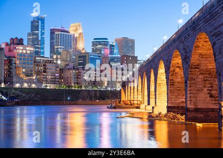 Minneapolis, Minnesota, USA skyline with the Stone Arch Bridge on the Mississippi River at blue hour. Stock Photo