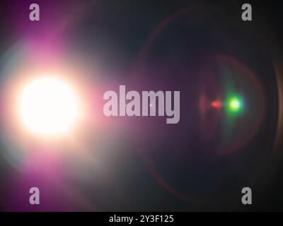 Bright star light flares in dark space background, creating epic array of colorful halos and reflections. Lens flare overlay effect. Stock Photo