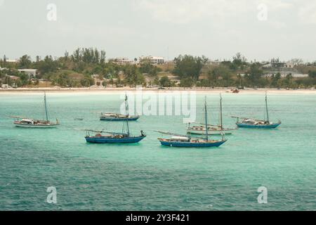 Nassau, Bahamas - April 15, 2008: Sloops are moored in the turquoise waters near the cruise port Stock Photo