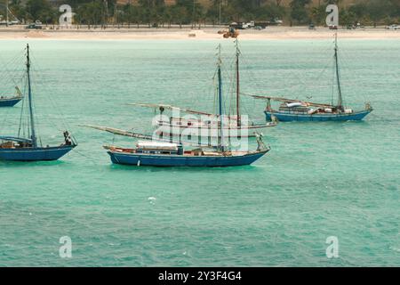 Nassau, Bahamas - April 15, 2008: Sloops are moored in the turquoise waters near the cruise port Stock Photo