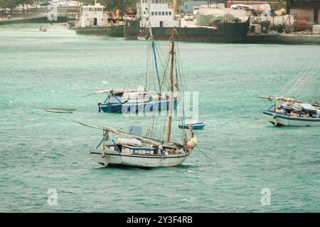 Nassau, Bahamas - April 15, 2008: Sloops are moored in the turquoise waters near the cruise port Stock Photo