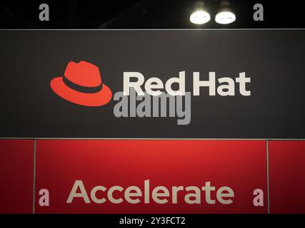LOS ANGELES, CA- May 22, 2024: Red Hat logo on Red Hat booth at AWS Summit in Los Angeles Convention Center Stock Photo