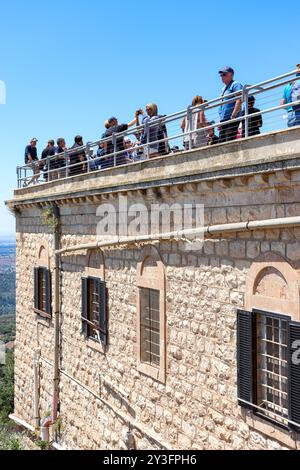 Side exterior view of The Muhraka Monastery roof top with tourist leaning on the safety rail located near the Druze village of Daliyat el-Carmel Stock Photo