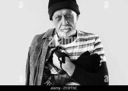 Mature homeless man on light background, closeup Stock Photo