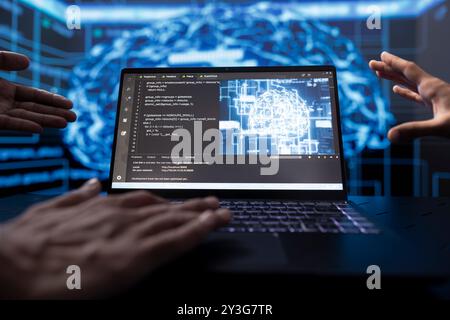 Software developers running AI cognitive computing tech on laptop to simulate computerized model. Close up of notebook used by IT experts in workplace to do data mining with self learning algorithms Stock Photo