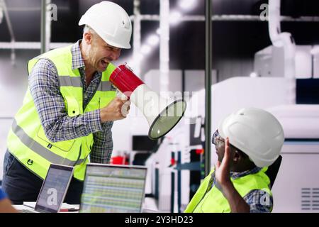 Group Dominator Bullying Diverse Engineers In Meeting Stock Photo