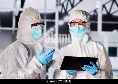 Sterile Semiconductor Manufacturing Factory And Worker In Coverall Stock Photo