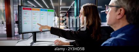 Scrum Project Manager Using Scrum Board Scheduling Software Stock Photo