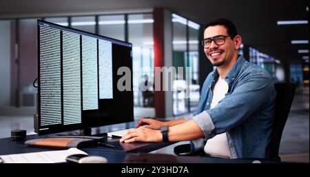 Computer Programmer Writing Program Code On Computer In Office Stock Photo