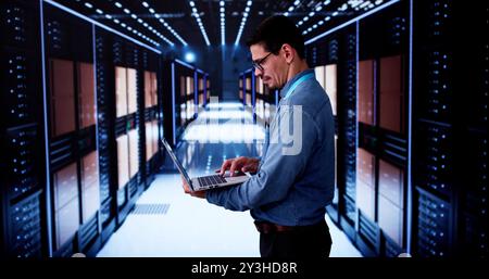 Happy Engineer In Data Center Server Room Configuring AI Technology Stock Photo