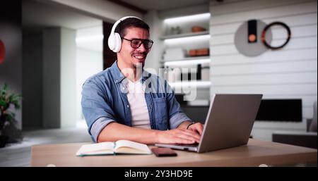 Male Student Studying With Computer Doing Research At Home Stock Photo