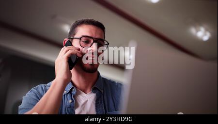 Portrait Of Young Happy Man Talking On Mobile Phone Stock Photo