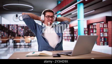 Hispanic Man Relaxing At Library While Using Laptop. Study Break Stock Photo