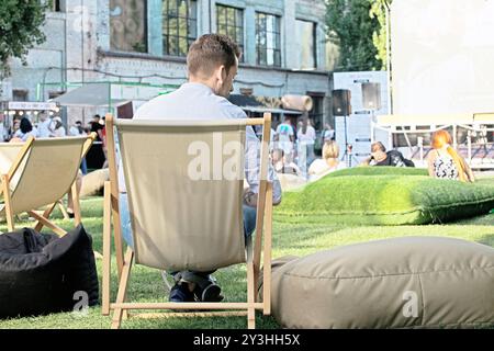 outdoor summer cinema with spectators on a sunny evening Stock Photo