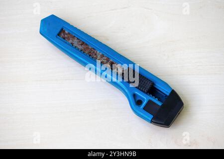 Rusted old cutter on a light wooden surface. Stock Photo