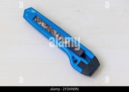 Rusty old cutter on a light wooden surface. Stock Photo