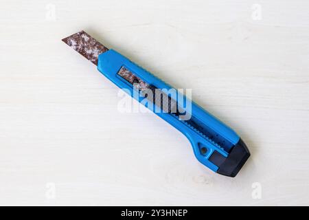 Rusty old knife on a light wooden surface. Stock Photo