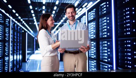 Server Room In Data Center. Cloud Computer Engineers Configuring AI Technology Stock Photo