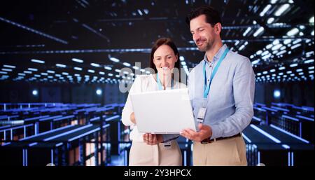 Server Room In Data Center. Cloud Computer Engineers Configuring AI Technology Stock Photo