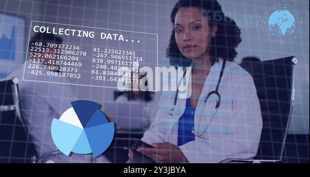 Image of diagrams and data processing over diverse doctors using tablet Stock Photo