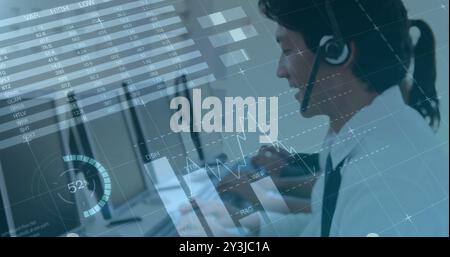 Image of financial data processing over asian businessman using phone headset and computer Stock Photo
