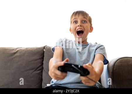 Child playing video game, excited expression Stock Photo