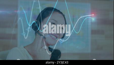 Image of financial data processing over asian businesswoman using phone headset and computer Stock Photo