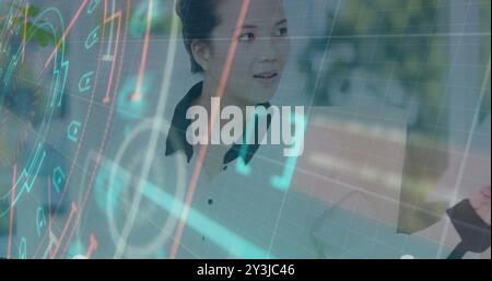 Image of financial data processing over asian businesswoman using computer Stock Photo