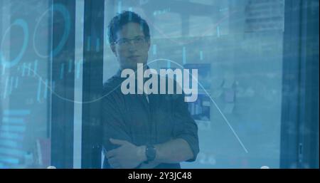 Businessman with arms crossed over financial data analysis image Stock Photo