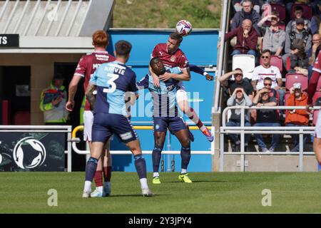 Northampton Town's Aaron McGowan climbs above Wycombe Wanderers Daniel Udoh to clear the ball during the first half of the Sky Bet League 1 match between Northampton Town and Wycombe Wanderers at the PTS Academy Stadium, Northampton on Saturday 14th September 2024. (Photo: John Cripps | MI News) Credit: MI News & Sport /Alamy Live News Stock Photo