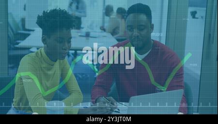 Image of financial data processing over diverse business people using laptop Stock Photo
